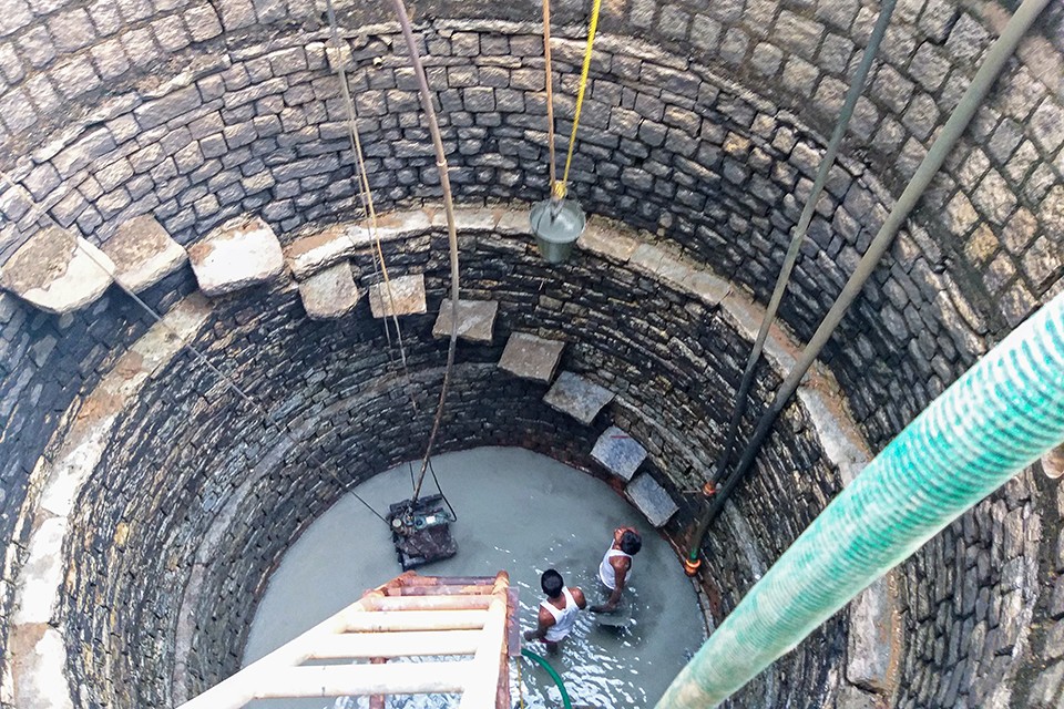An old well being cleaned and revived by mannu vaddars traditional well diggers under the million wells for bengaluru project - Decoding India’s Water Crisis, With The Zenrainman | Nature inFocus