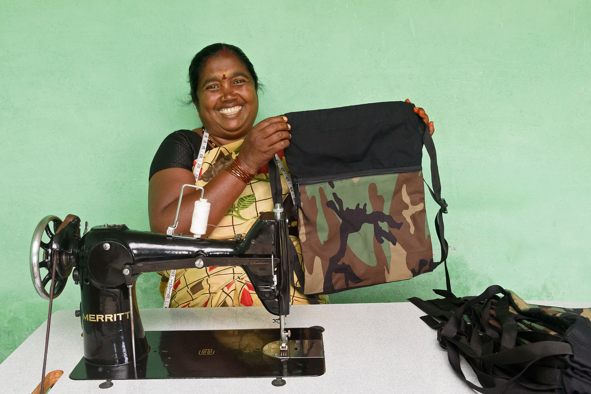 A member of the Alternate Livelihoods Program with a drawstring bag she stitched herself for forest frontline staff