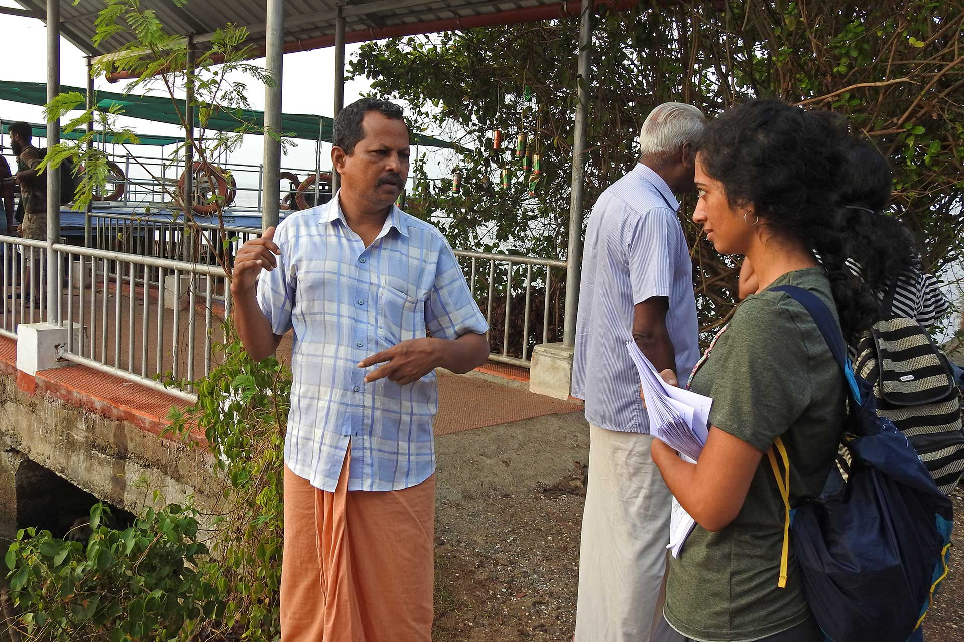Scientist talking to fishermen in vembanad lake