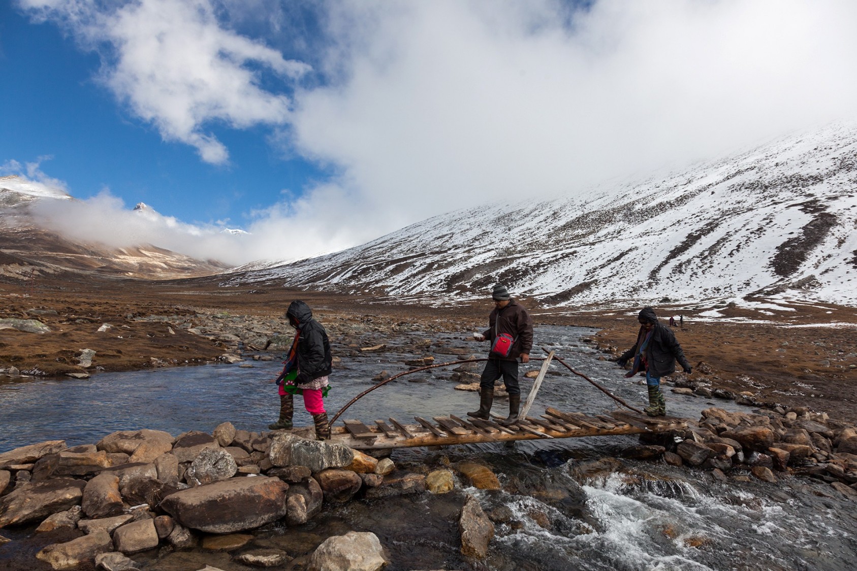Visitors crossing a makeshift bridge over a glacial stream at Zero point, near Yumthang, North Sikkim. This place is a huge draw for tourists looking to spend some time in the snow. I started out from Lachung early in the morning, but my bike got caught in a stream. Somehow, with numb feet and a cold body, I made it to Zero point. The air was too thin and the weather too windy to enjoy the beauty for long.