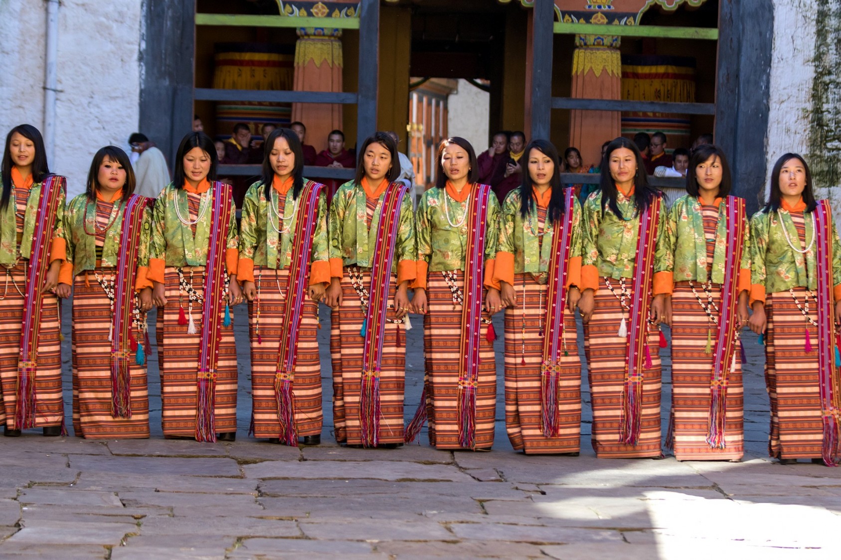 Ladies in traditional attire performing a slow-moving dance in Bumthang, Bhutan.